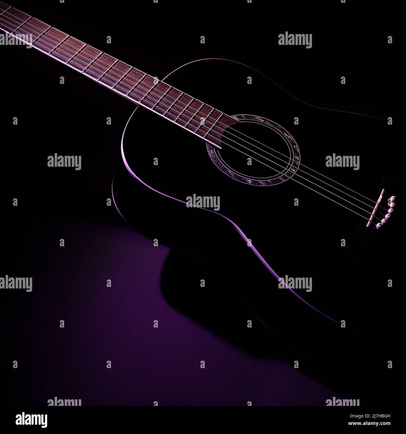 black guitar against a dark background, isometric view. guitar music