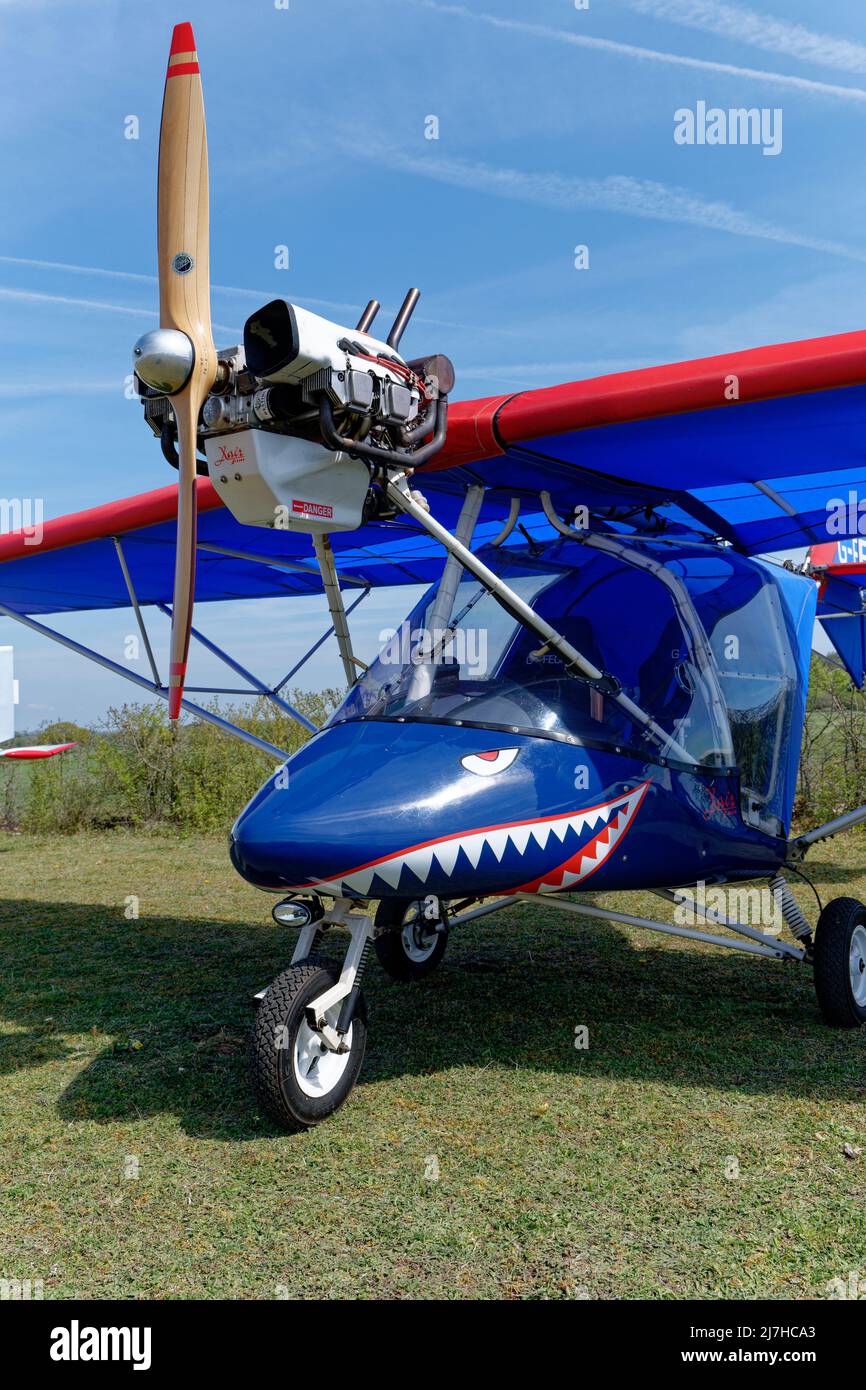 The shape of the nose cone on this bright blue X'Air Jabiru microlight airplane is ideal for the shark face artwork that has been beautifully applied. Stock Photo