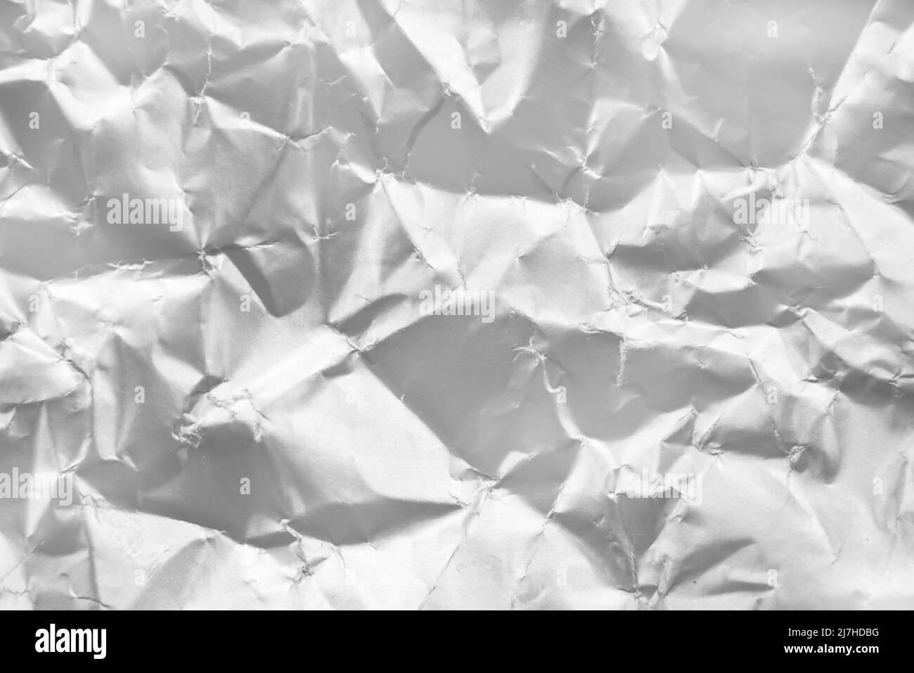Background from crumpled paper in silver color. Paper with scuffs and waves Stock Photo