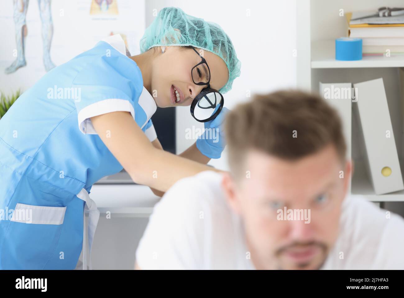 Woman dermatologist examine male patient body, check skin on back with