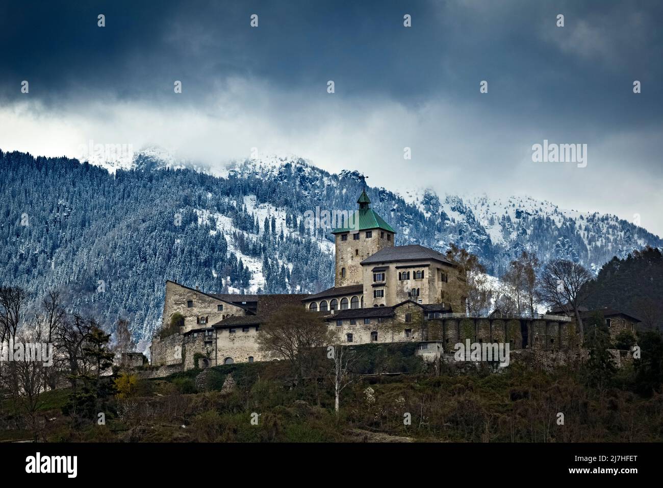 The imposing fortified structure of Ivano castle stands out among the Valsugana mountains. Castel Ivano, Trento province, Trentino Alto-Adige, Italy. Stock Photo