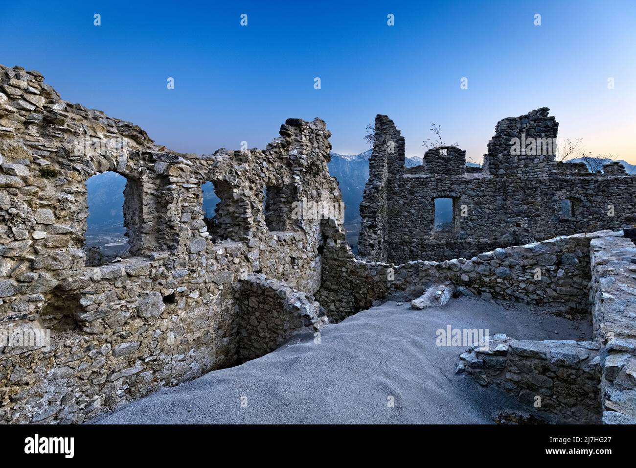 Ruins of the medieval wall with loopholes of Castellalto castle. Telve, Trento province, Trentino Alto-Adige, Italy, Europe. Stock Photo