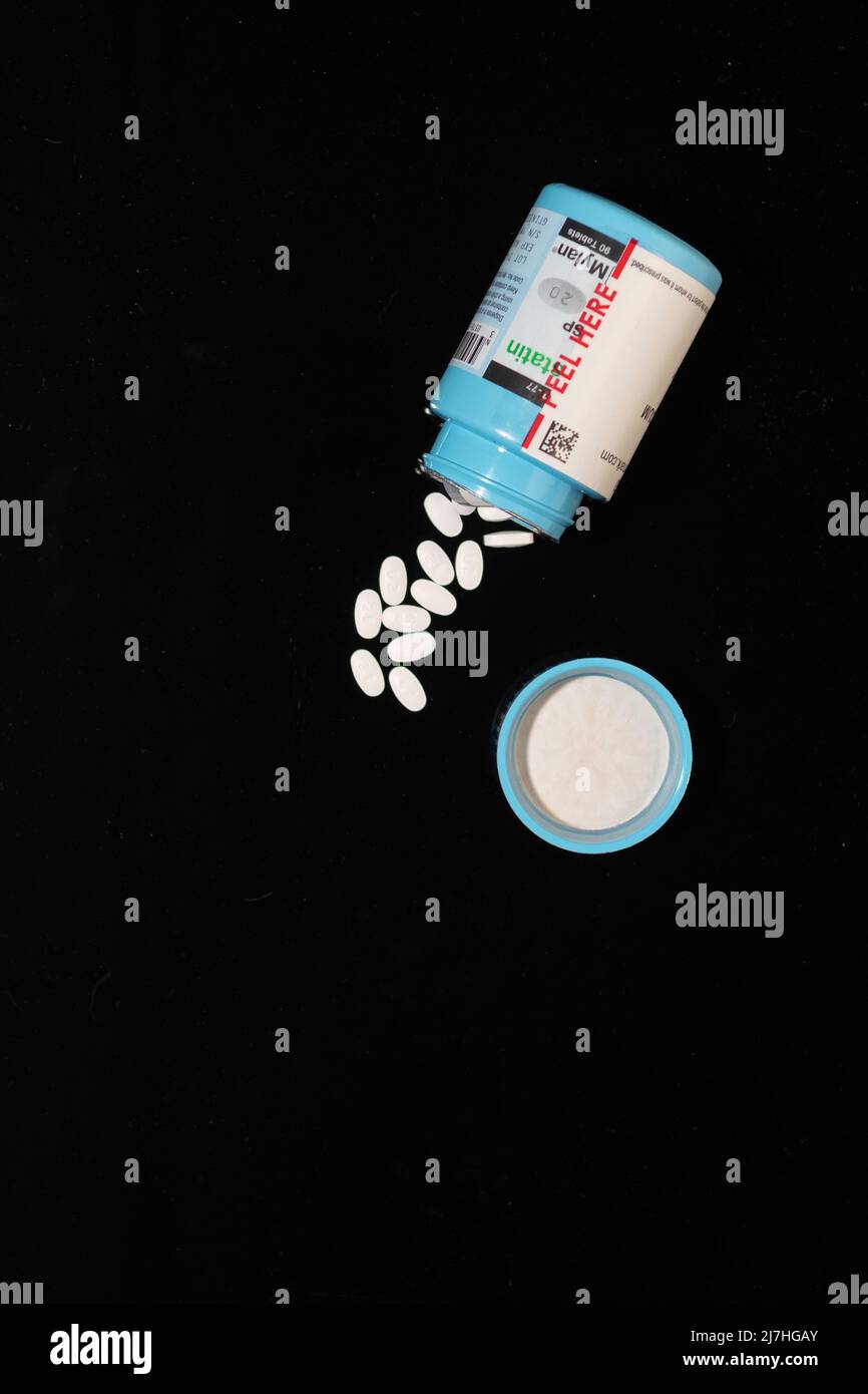 Open pill bottle of prescription medication with pills spilling out Stock Photo