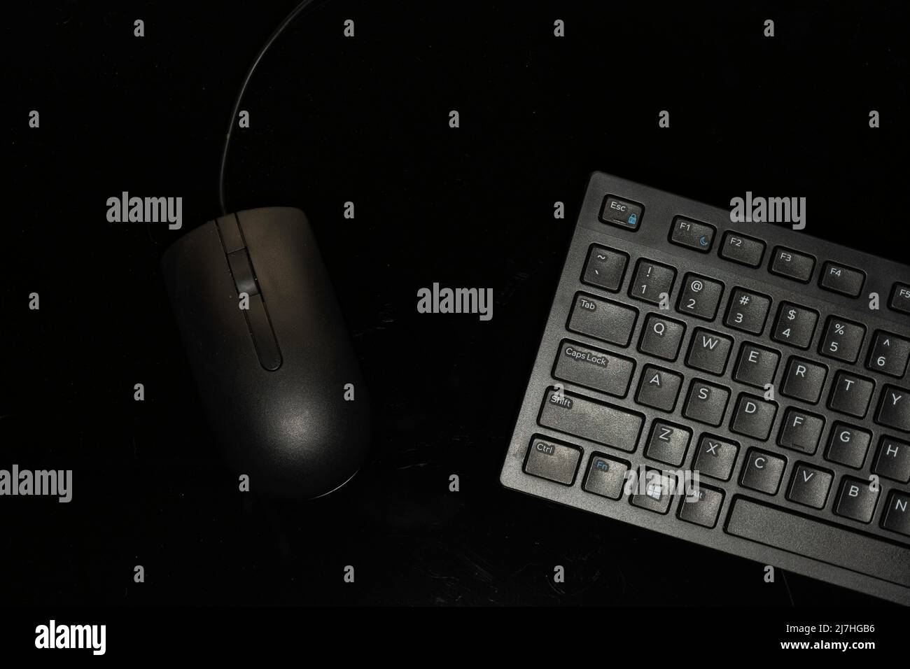 Computer mouse and portion of standard size keyboard isolated on black background Stock Photo