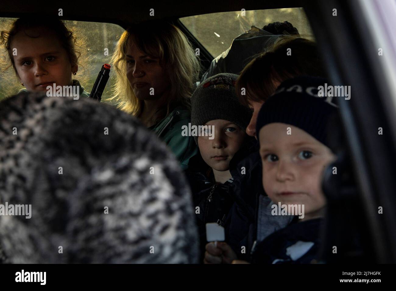 Sophia (L1, 7), Igor (L3, 8) Sergei (L4, 2.5) are seen packed in the car with their parents as they depart to other cities after arriving in Zaporizhia from Kherson on Sunday. Amid the intensified war crisis in Southeast Ukraine, millions of Ukrainian families have now been evacuated from the war zones and Russia controlled territories to Ukraine controlled territories, Zaporizhia.According to the United Nations, more than 11 million people are believed to have fled their homes in Ukraine since the conflict began, with 7.7 million people displaced inside their homeland. Stock Photo