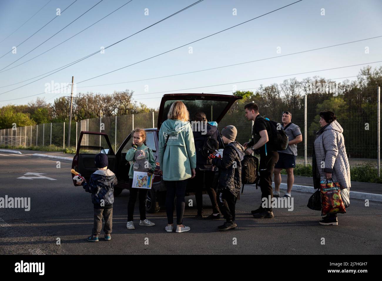 Sophia (L1, 7), Igor (L3, 8) Sergei (L4, 2.5) pack their belongings in the car with their parents as they depart to other cities after arriving in Zaporizhia from Kherson. Amid the intensified war crisis in Southeast Ukraine, millions of Ukrainian families have now been evacuated from the war zones and Russia controlled territories to Ukraine controlled territories, Zaporizhia.According to the United Nations, more than 11 million people are believed to have fled their homes in Ukraine since the conflict began, with 7.7 million people displaced inside their homeland. Stock Photo