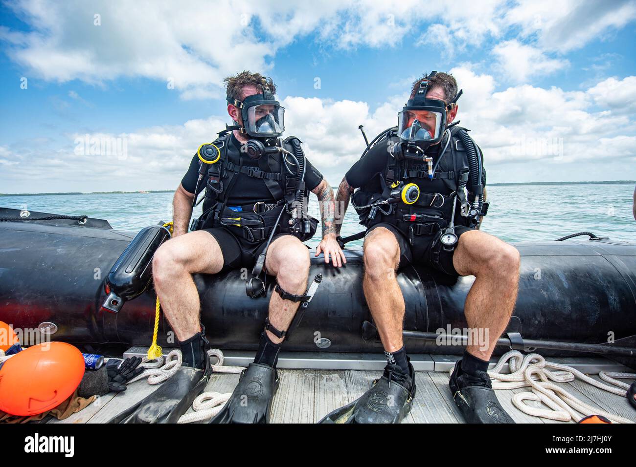 Belize City, Belize. 08th May, 2022. Sailor First Class Lucas Kozuch, left, and Sailor First Class Brooks Robinson with the Canadian Armed Forces prepare to enter the water for a reconnaissance dive during the regional training exercise Tradewinds 22, May 8, 2022 in Belize City, Belize. Credit: Cpl Alevtina Ostanin/U.S. Army/Alamy Live News Stock Photo