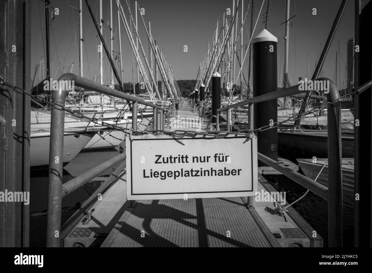 a sign on a jetty says access only for berth holders Stock Photo