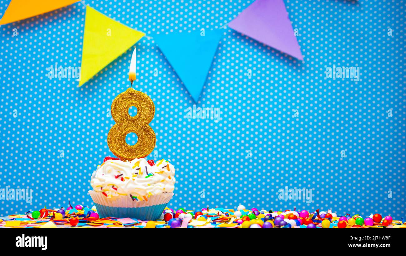 Cream cupcake with birthday candle, colorful happy birthday card ...