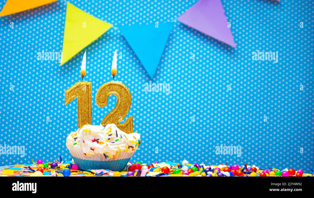 Cream cupcake with birthday candle, colorful happy birthday card ...