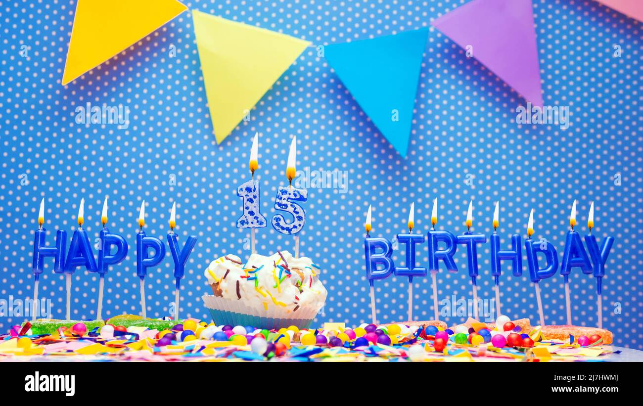Happy birthday candle letters with a number or digit on a beautiful blue background. Copy space Happy birthday greetings card, lit candles Stock Photo
