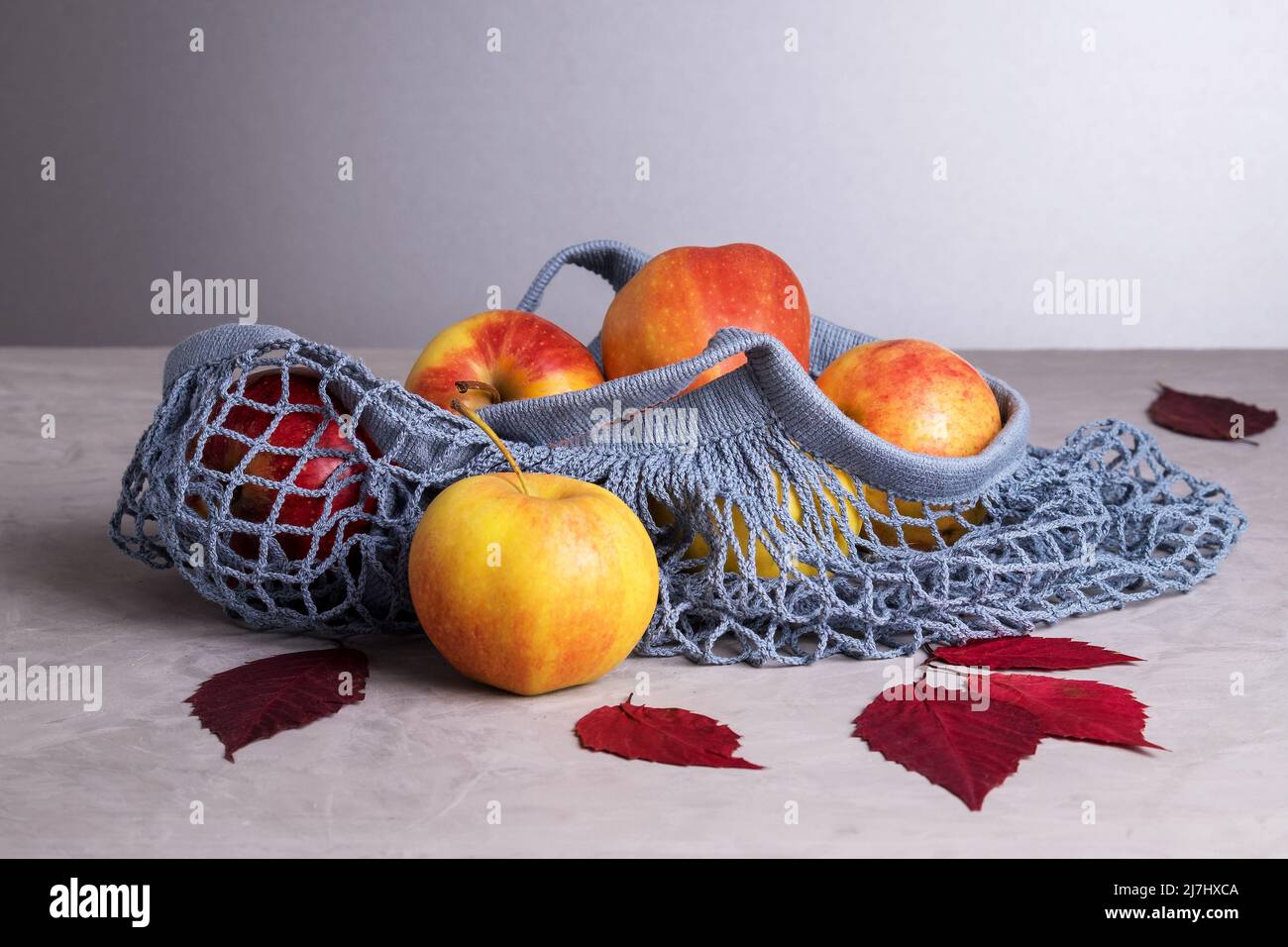 Apples in eco friendly reusable mesh bag made from recycled materials Stock Photo