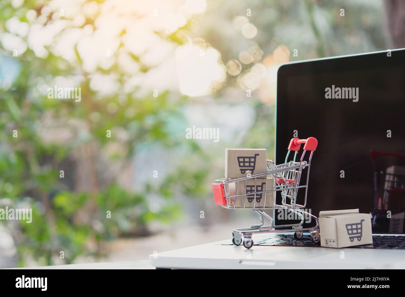 Shopping online. Cardboard box with a shopping cart logo in a trolley