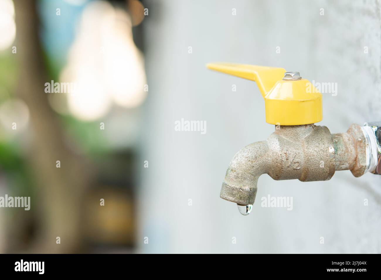 Faucet with a water drop. Old yellow faucet Stock Photo Alamy