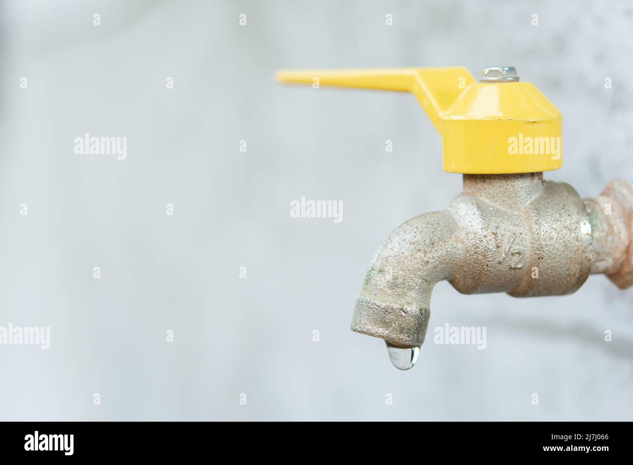 Faucet with a water drop. Old yellow faucet Stock Photo Alamy