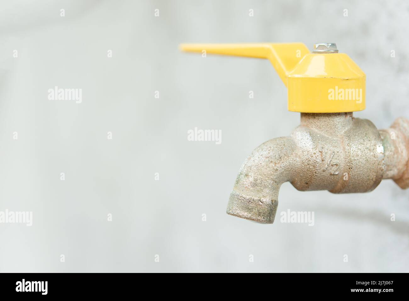 Faucet with a water drop. Old yellow faucet Stock Photo Alamy