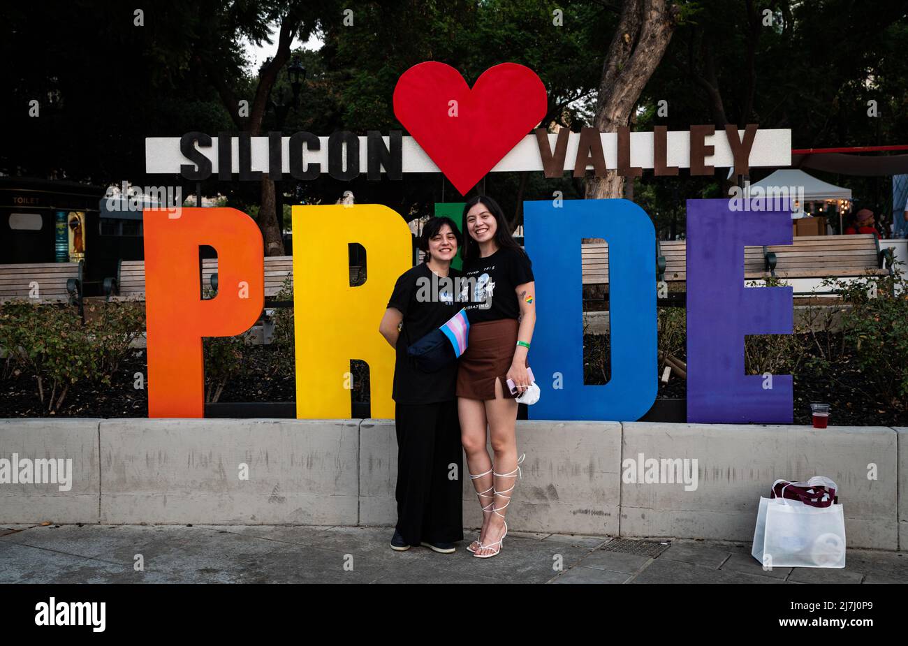 Mel MJ Sisters Genesis  and MJ pose under the official Silicon Valley sign holding a pink and blue bisexual flag. Stock Photo