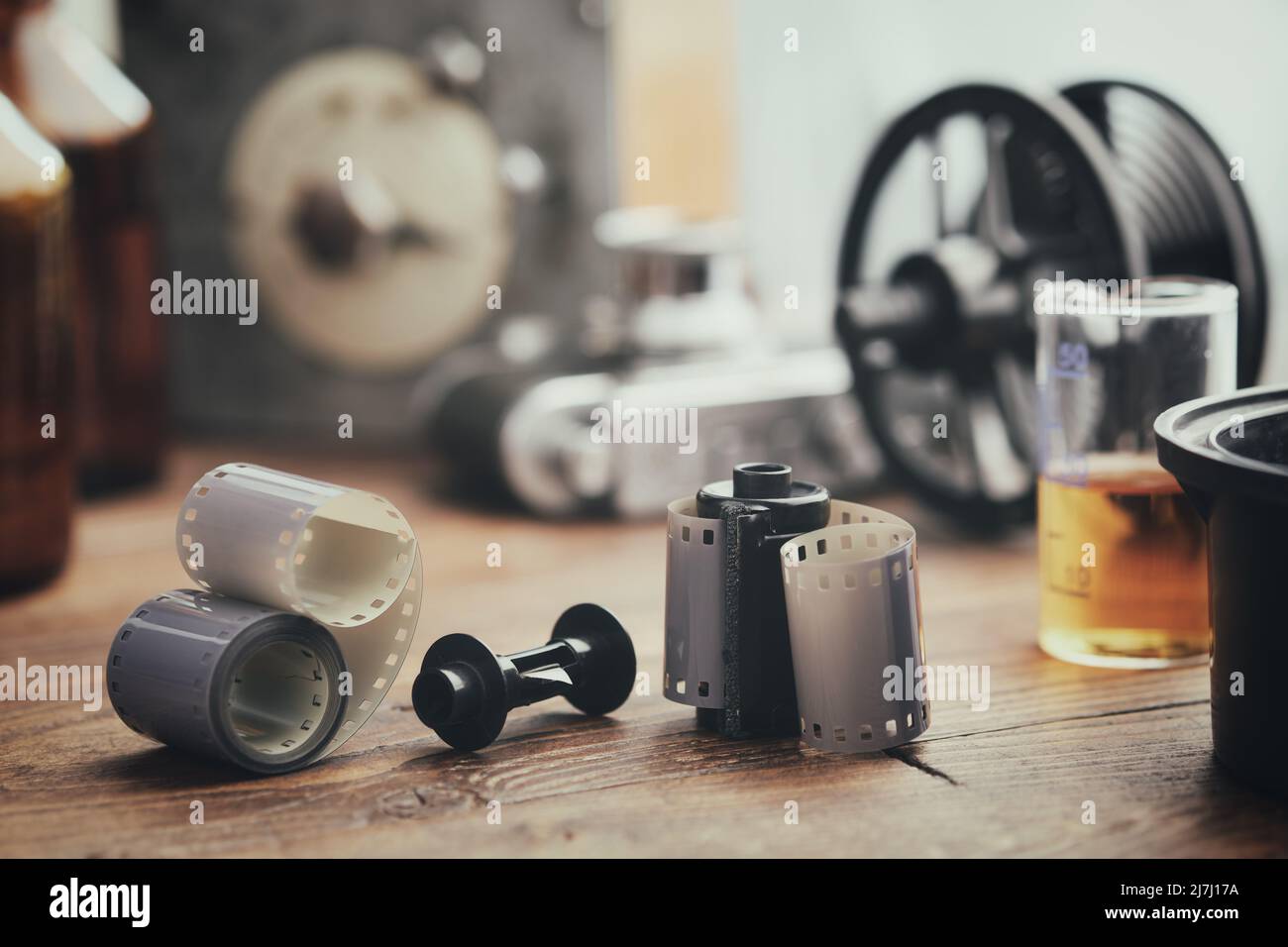 Old photo film rolls, cassette and photographic equipment on background - developing tank with its film reels, retro camera, timer and chemical reagen Stock Photo