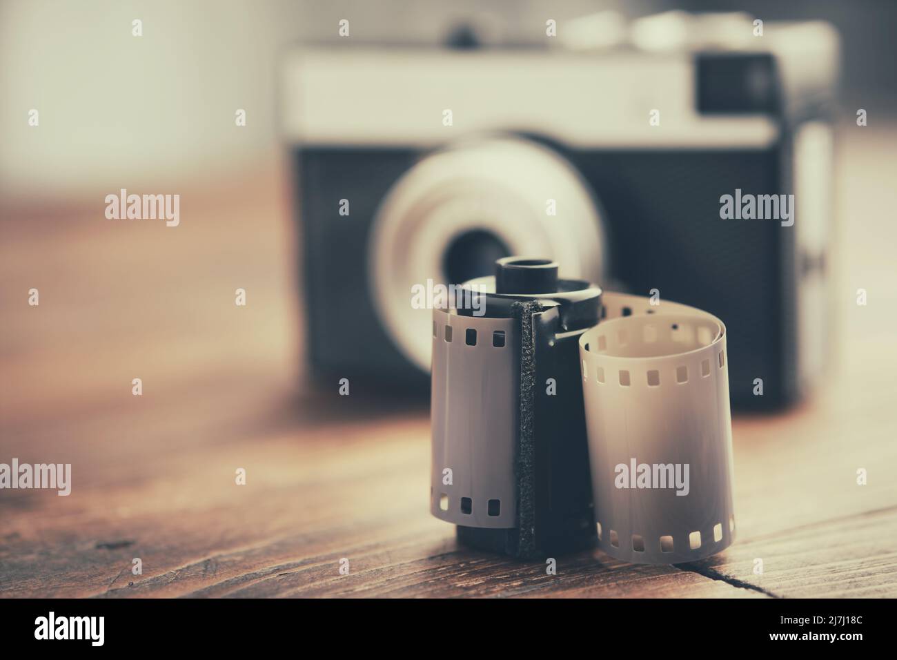 Old photo film rolls, cassette and retro camera on background. Stock Photo