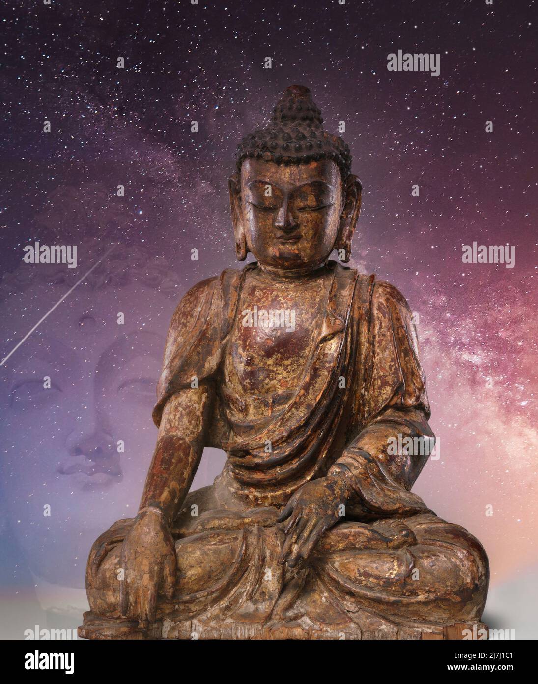 Buddha in meditation under a starry sky. Stock Photo