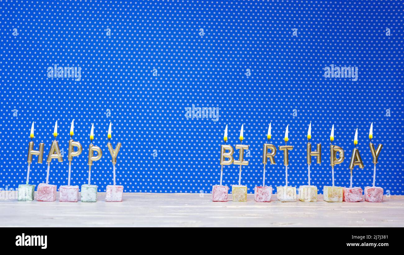 Happy birthday from candle letters on a blue background with white ...