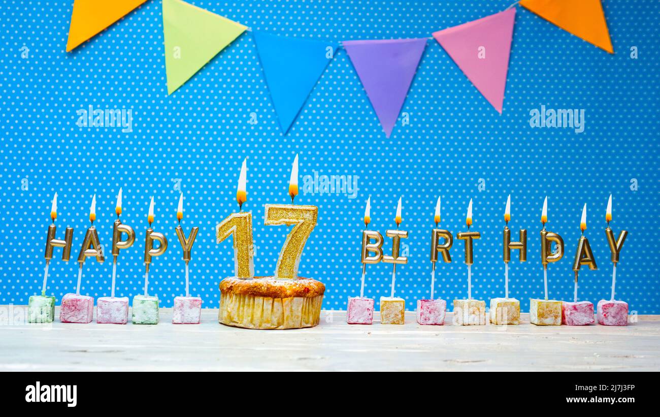 Happy birthday from candle letters on a blue background with white