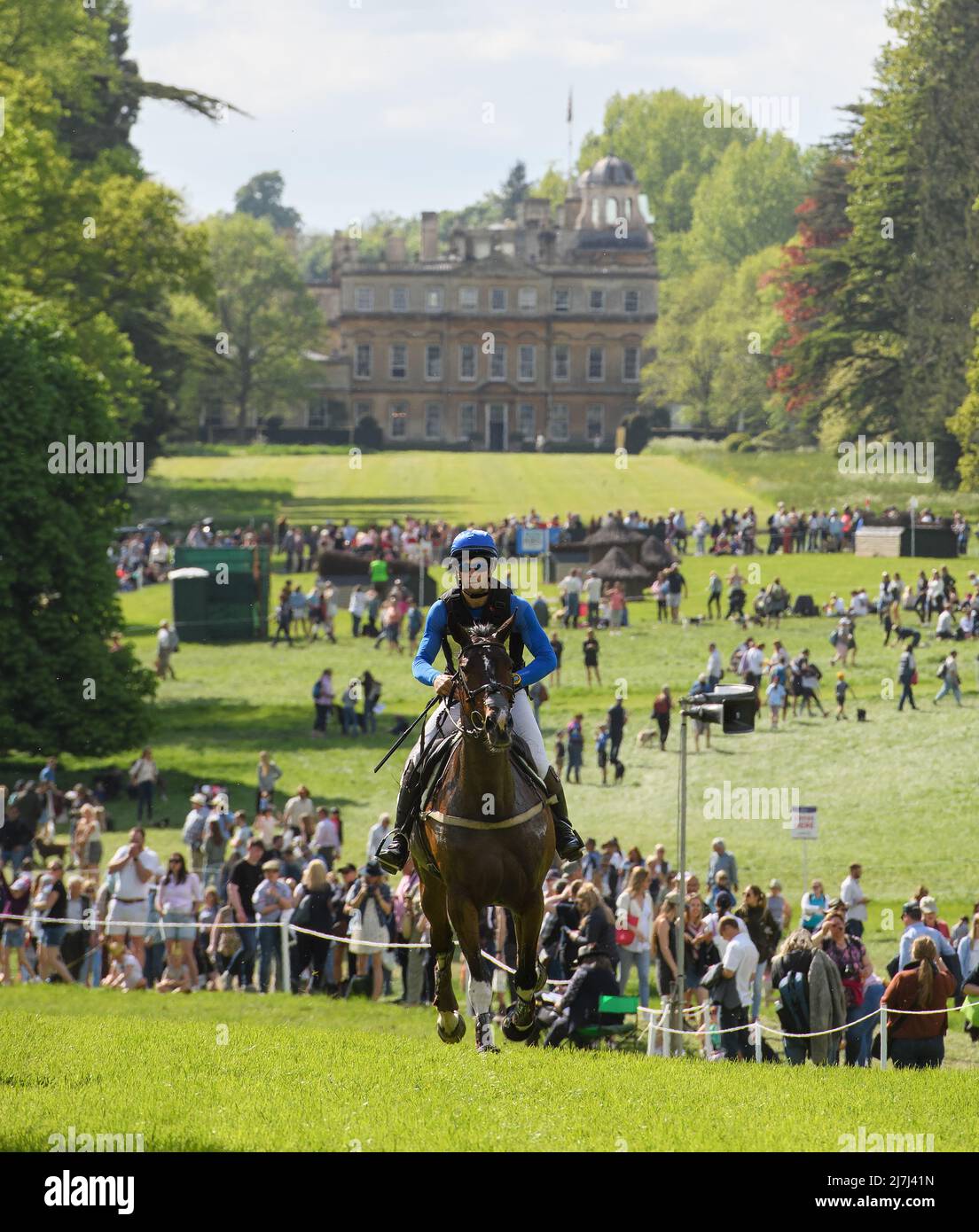Badminton Horse Trials - Cross Country Test - Badminton, UK. 07th May, 2022. Arthur Chabert riding Goldsmiths Imber gallops with Badminton House in the background during the Cross Country Test at the Badminton Horse Trials. Picture Credit : Credit: Mark Pain/Alamy Live News Stock Photo