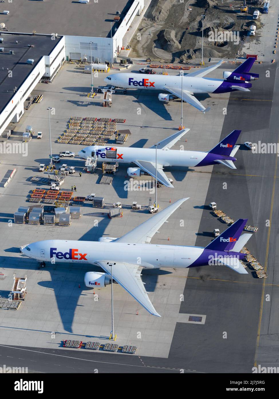 Airplane of FedEx Cargo at Anchorage Airport, a hub for freight transportation for Federal Express. Line up of freighter aircraft. Stock Photo