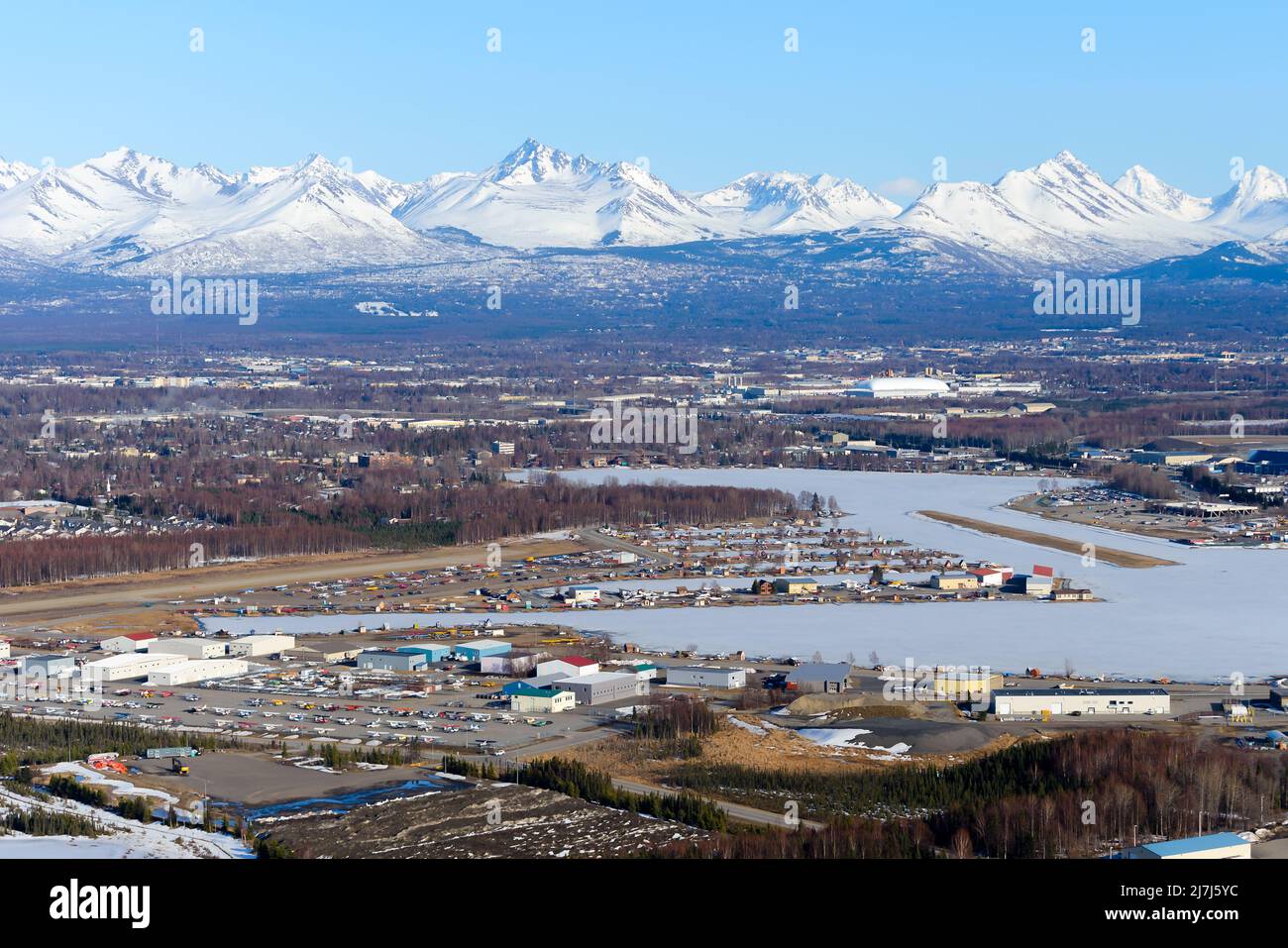Lake Hood Seaplane Base aerial view in Anchorage. Busiest seaplane base in the world located on Lakes Hood and Spenard with snow capped mountains. Stock Photo