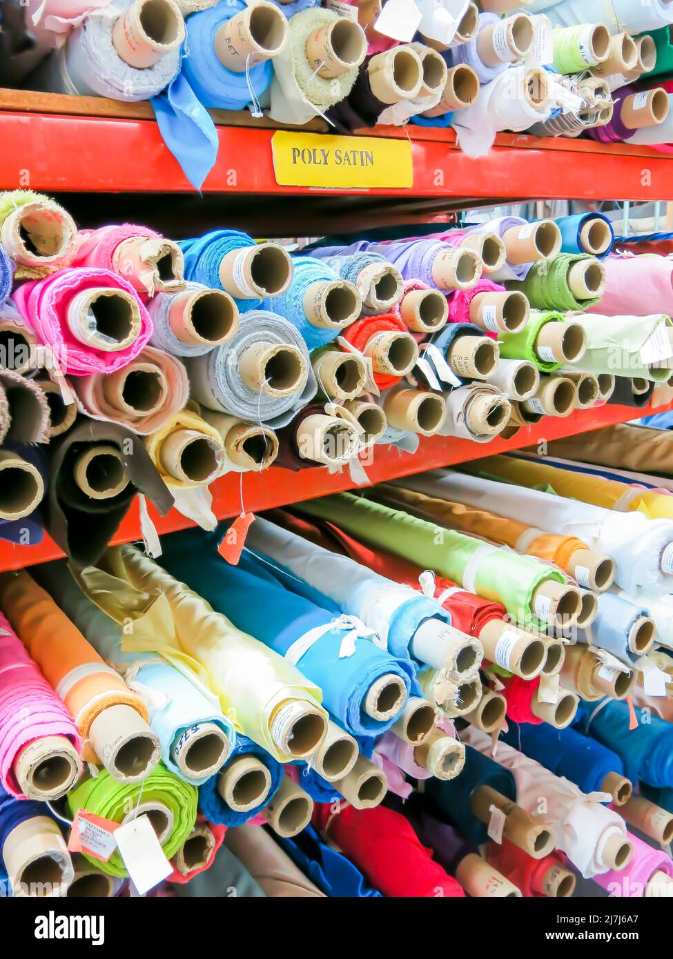 Rolls of Fabric on Store Shelves Ready for Purchase Stock Photo