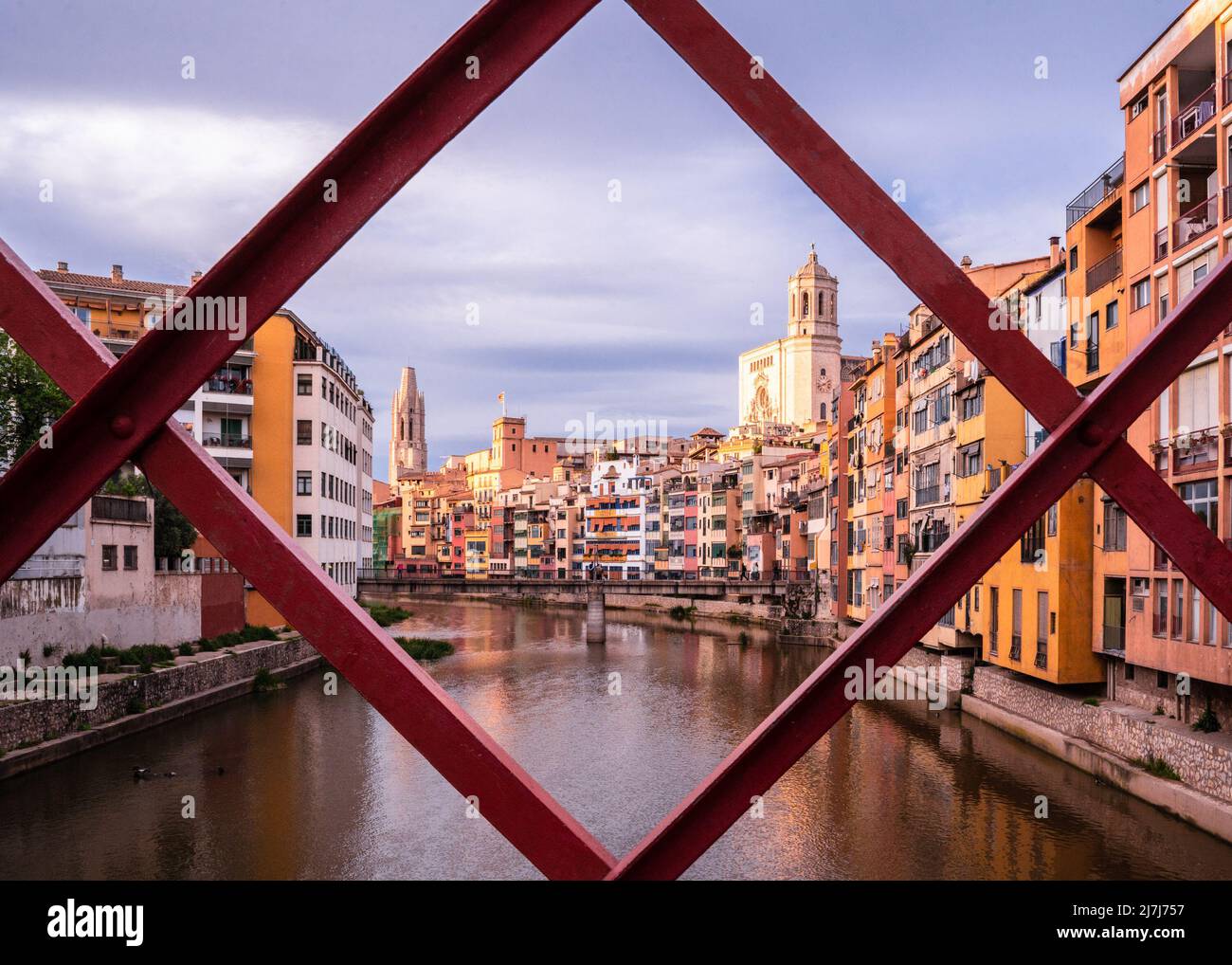 Beautiful Medieval city of Girona Spain seen through fence on canal Stock Photo
