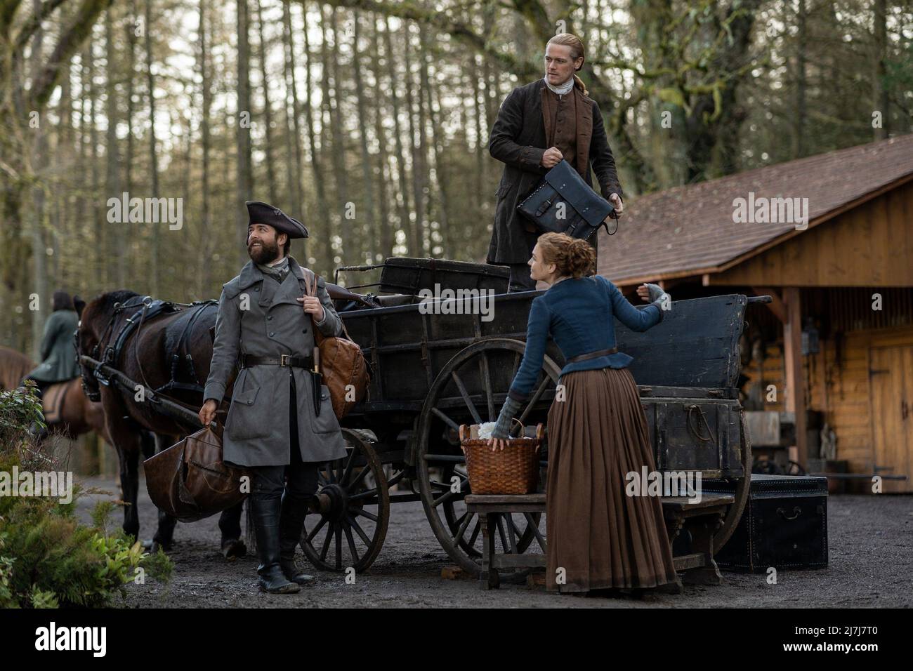 OUTLANDER, from left Richard Rankin, Sam Heughan, Sophie Skelton (back to camera), The World