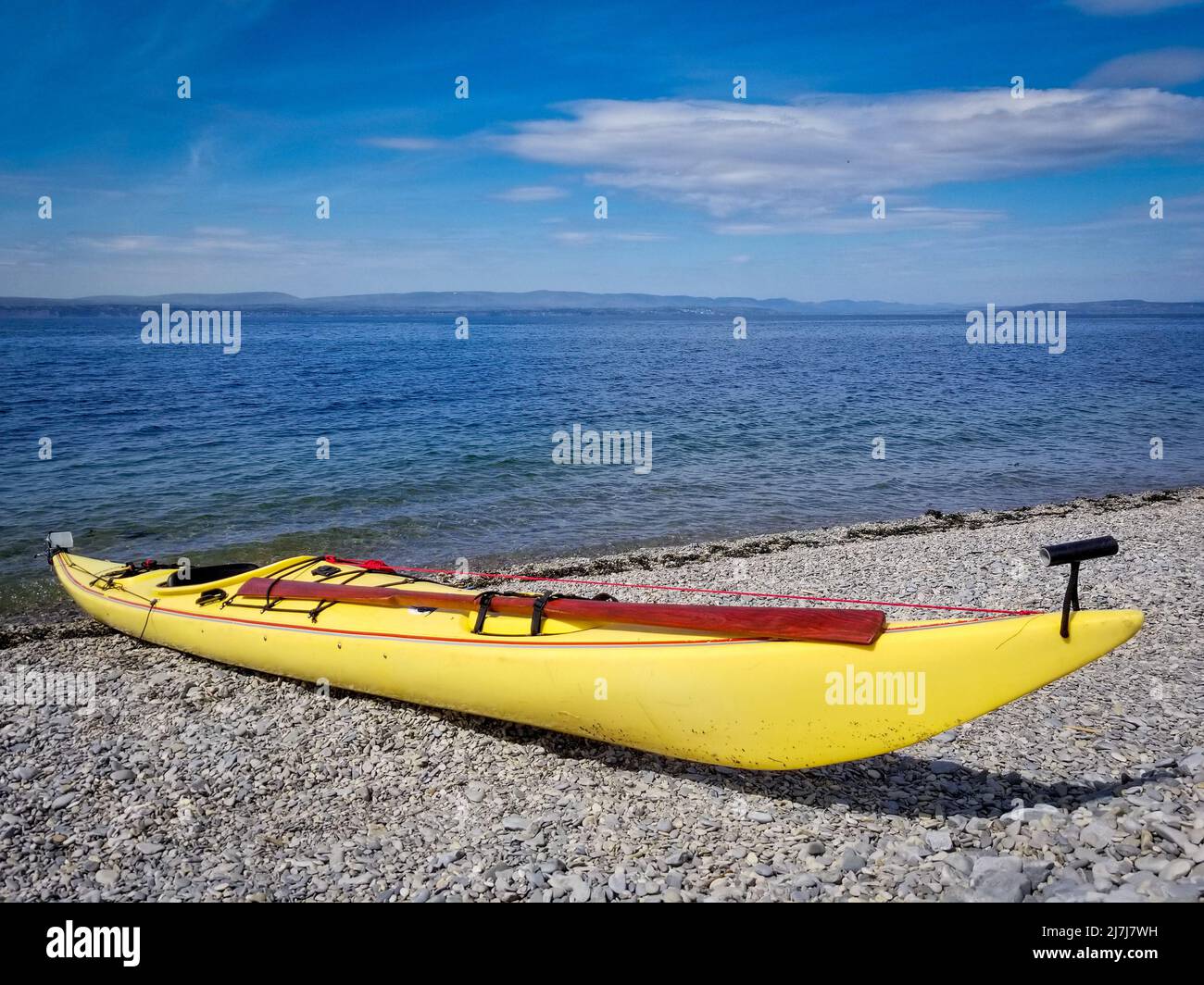 Modern sea kayak with traditional Greenland style paddle. Stock Photo