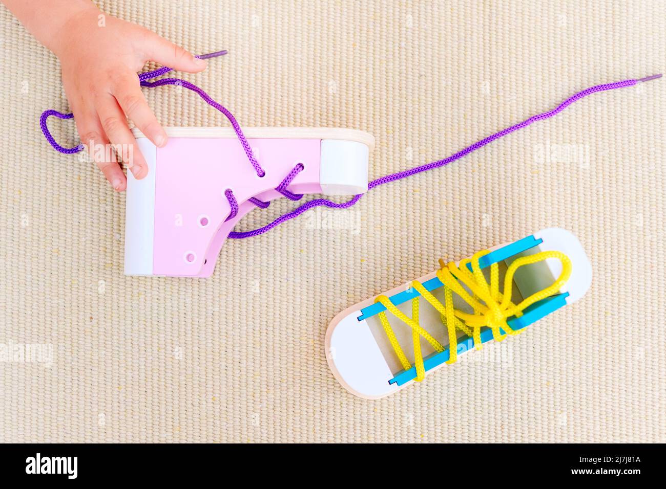 Montessori educational material to learn how to tie shoelaces Stock