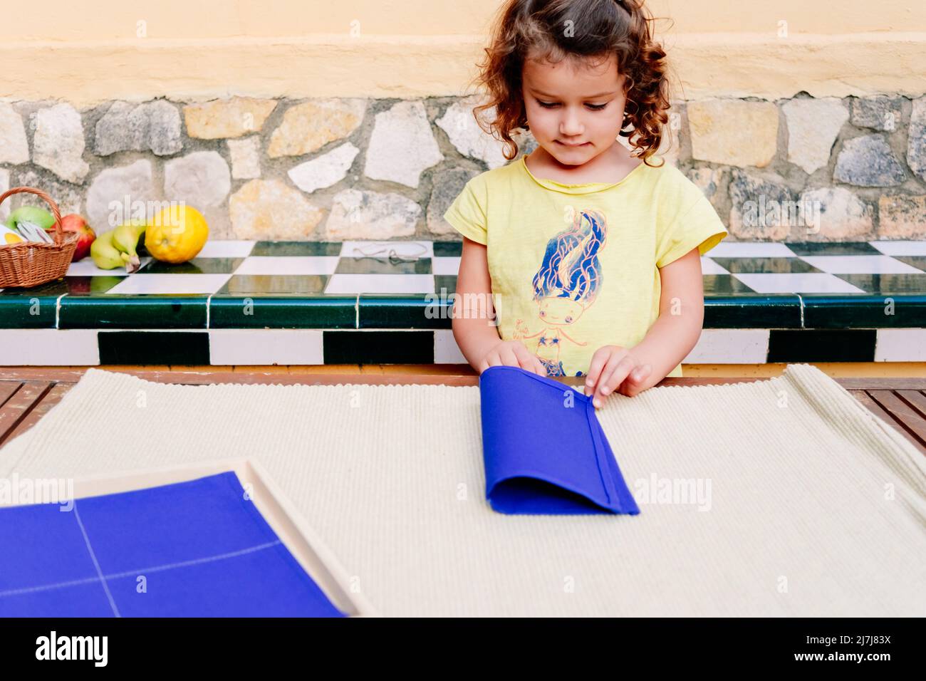 Folding napkins for children is a task to improve the fine motor skills