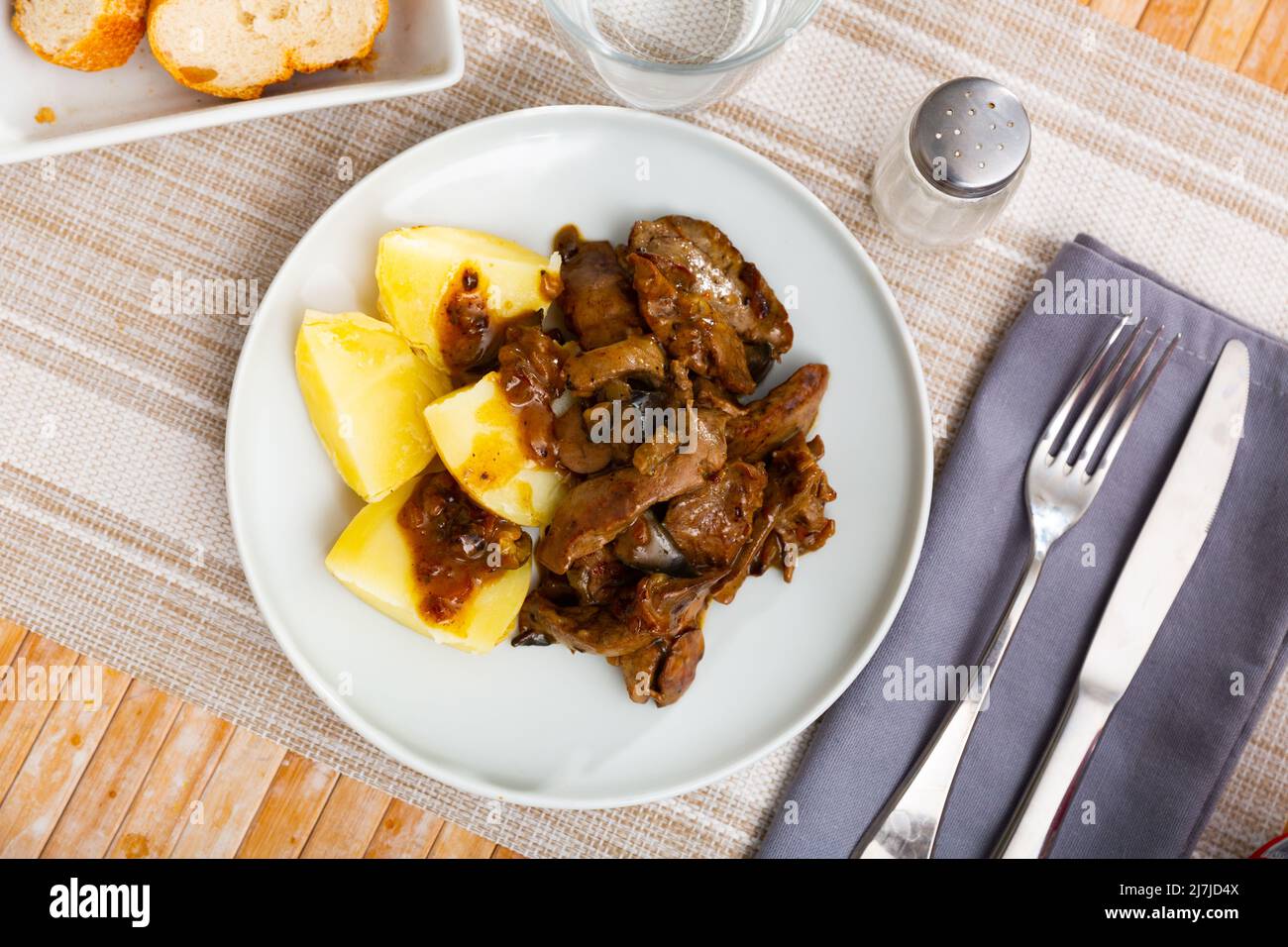 Fried rabbit liver served with boiled potato Stock Photo - Alamy