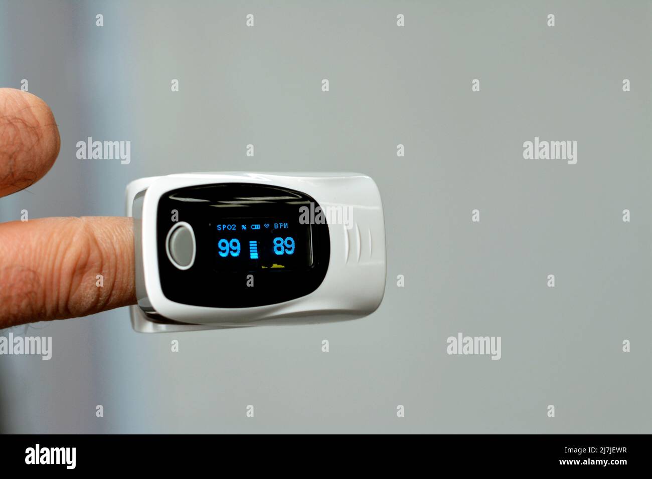 fingertip pulse oximeter equipment connected to the index finger of a