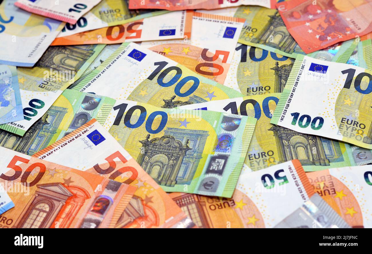 A background of a pile of different euro bill banknotes of 100 one hundred euros bill, 50 fifty euro bills and 20 twenty euros, European cash money ex Stock Photo