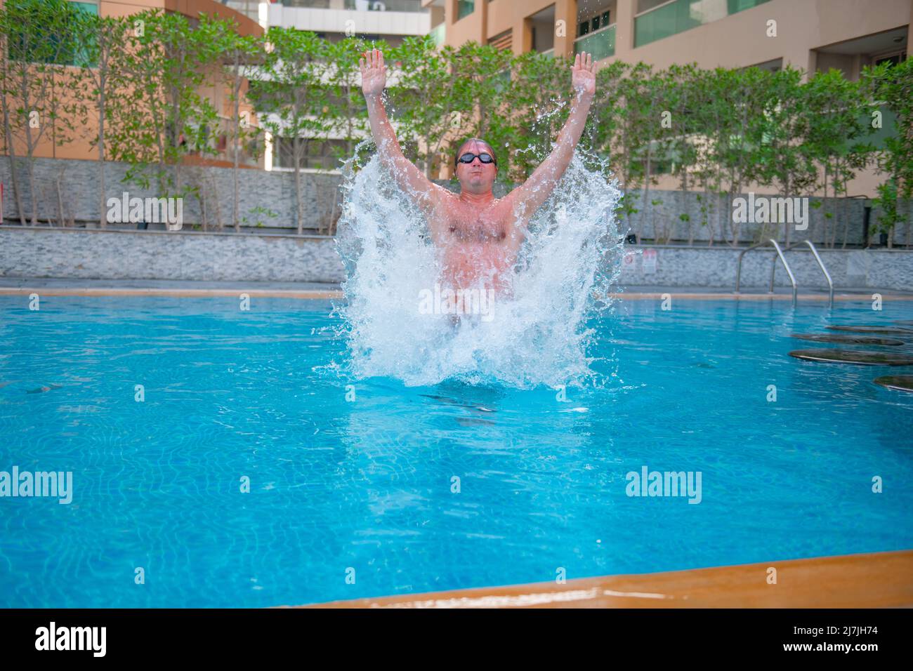 man jumps up in a big pool Stock Photo Alamy