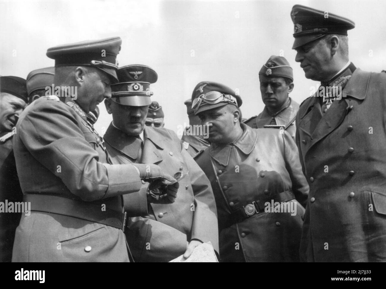 Adolf Hitler with officers in France in 1940. Visible are: Field Marshals Gunther von Kluge (1st left) and Wilhelm Keitel (1st right) and Martin Bormann (centre right with goggles on his cap) Stock Photo