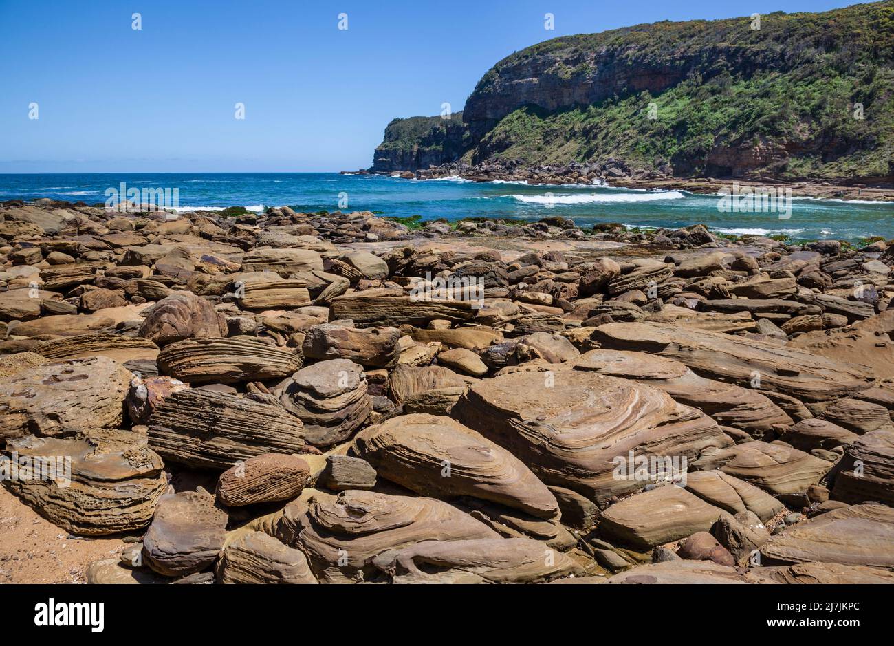 rock-strewn shoreline at secluded Little Beach in  Bouddi National Park on the Central Coast of New South Wales, Australia Stock Photo