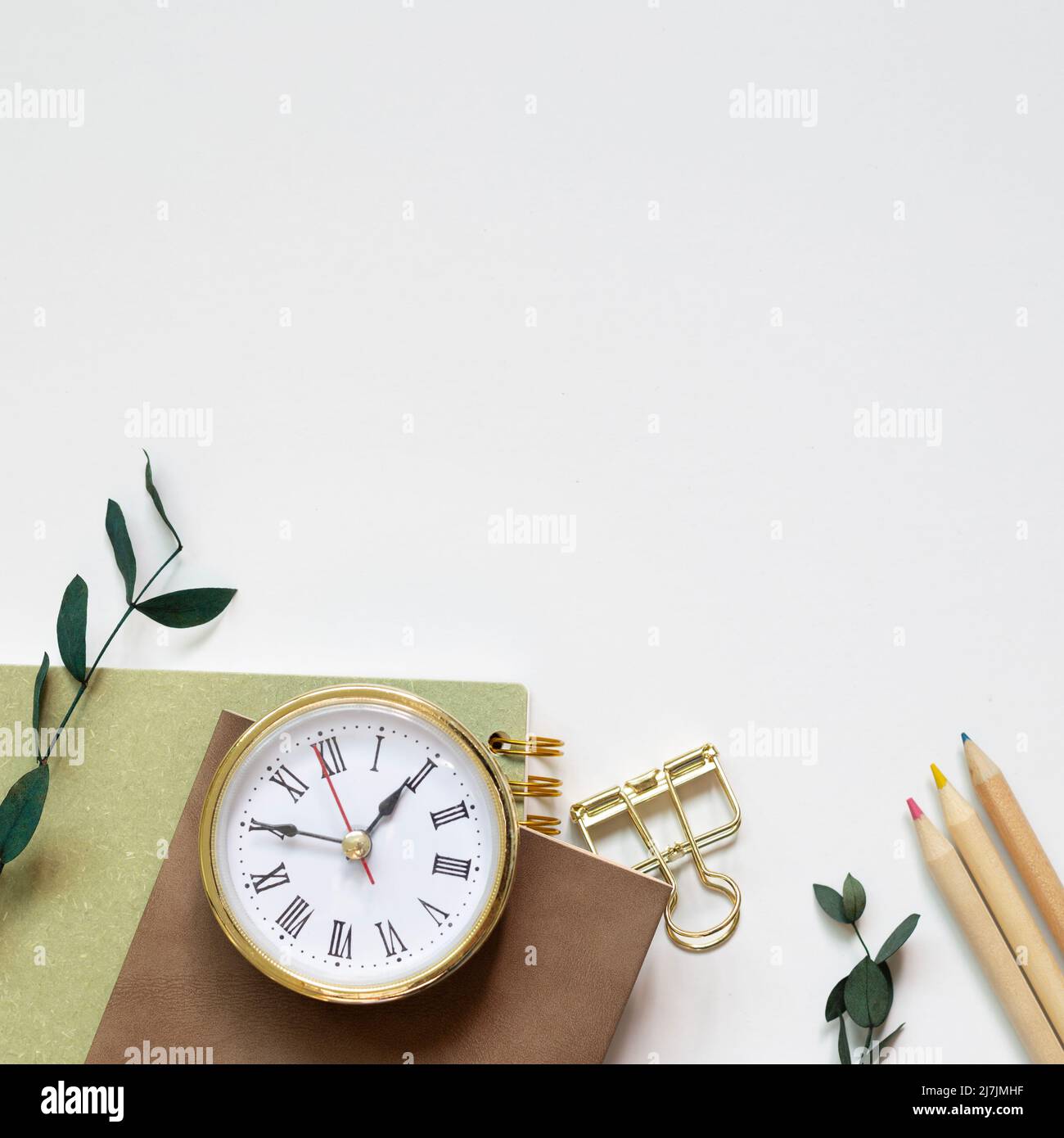 Notebook, pencil, clip, clock on white background. flat lay, top view, copy space Stock Photo