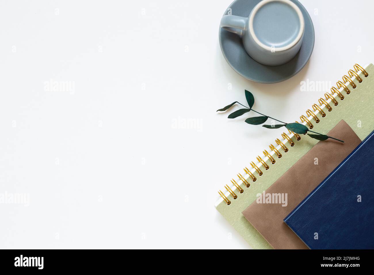 Notebook, coffee cup on white background. flat lay, top view, copy space Stock Photo