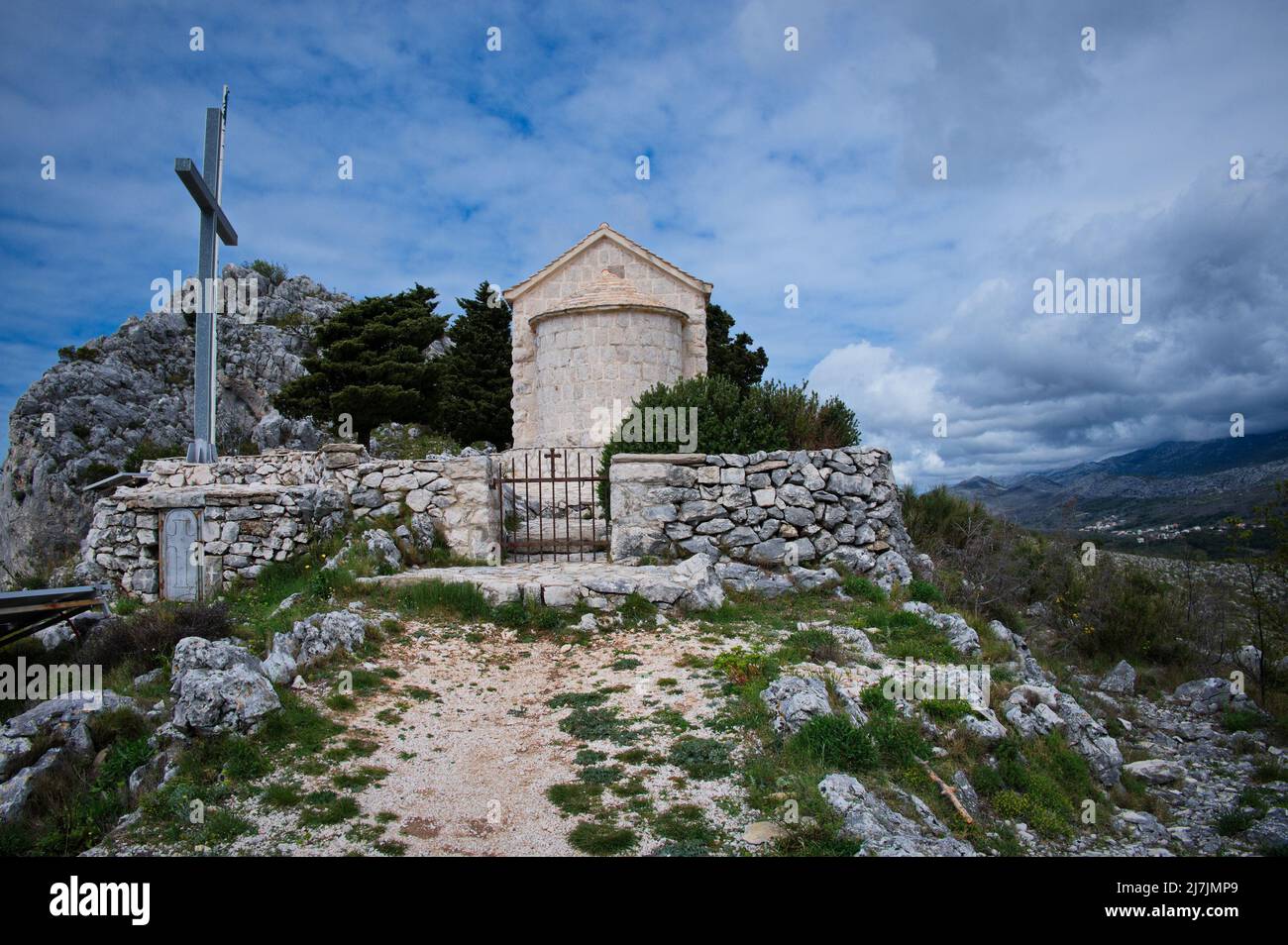 Small medieval stone church on the top of the hill Stock Photo
