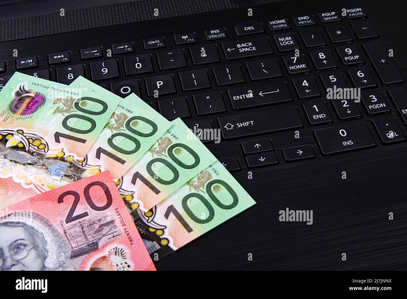 Australian bank notes on a black computer keyboard Stock Photo