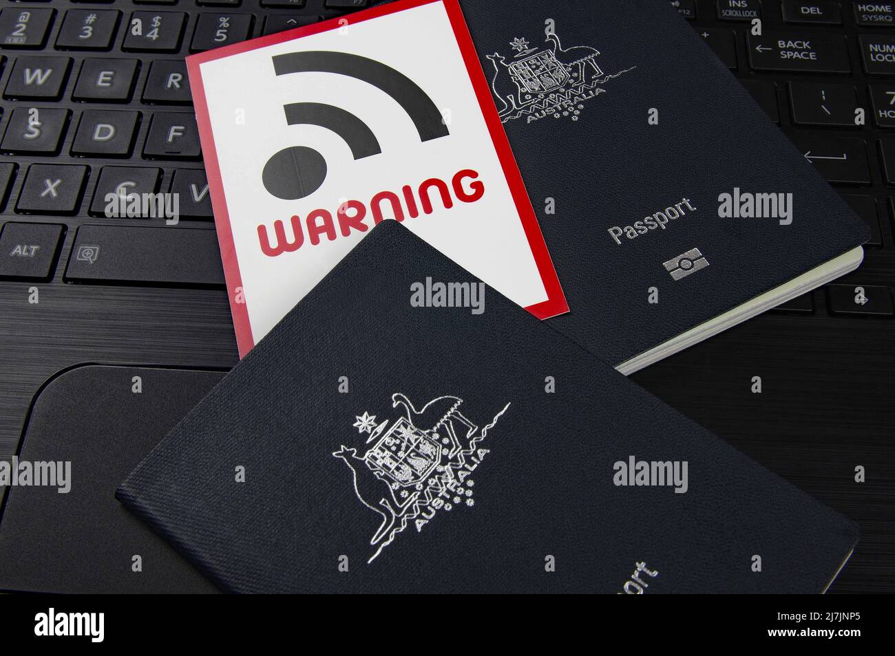 passports and WIFI security warning sign on a computer keyboard Stock Photo