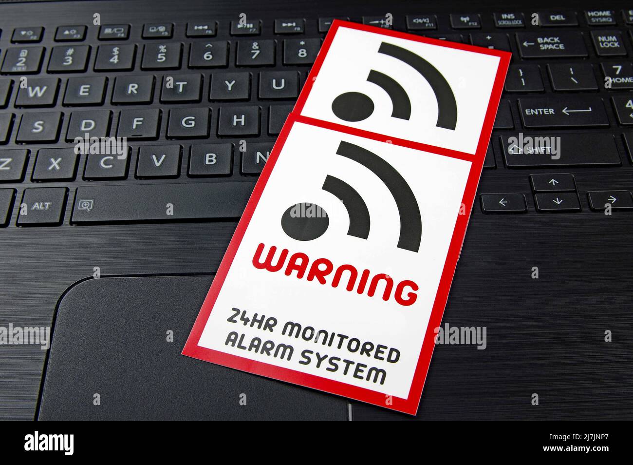 computer WIFI warning sign on a black laptop keyboard Stock Photo