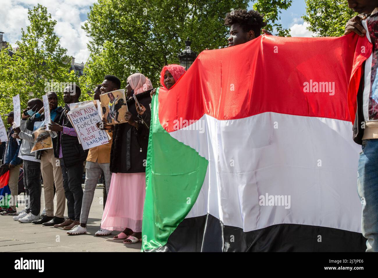 Paris, France. 08th May, 2022. Protesters hold the Sudanese flag and placards expressing their opinion concerning the situation in Sudan during a demonstration in the center of Paris. Around a hundred participants in Paris gathered together to call for a democratic political system in Sudan and denounced the violence against citizens in Sudan. (Photo by Léa Ferté/SOPA Images/Sipa USA) Credit: Sipa USA/Alamy Live News Stock Photo