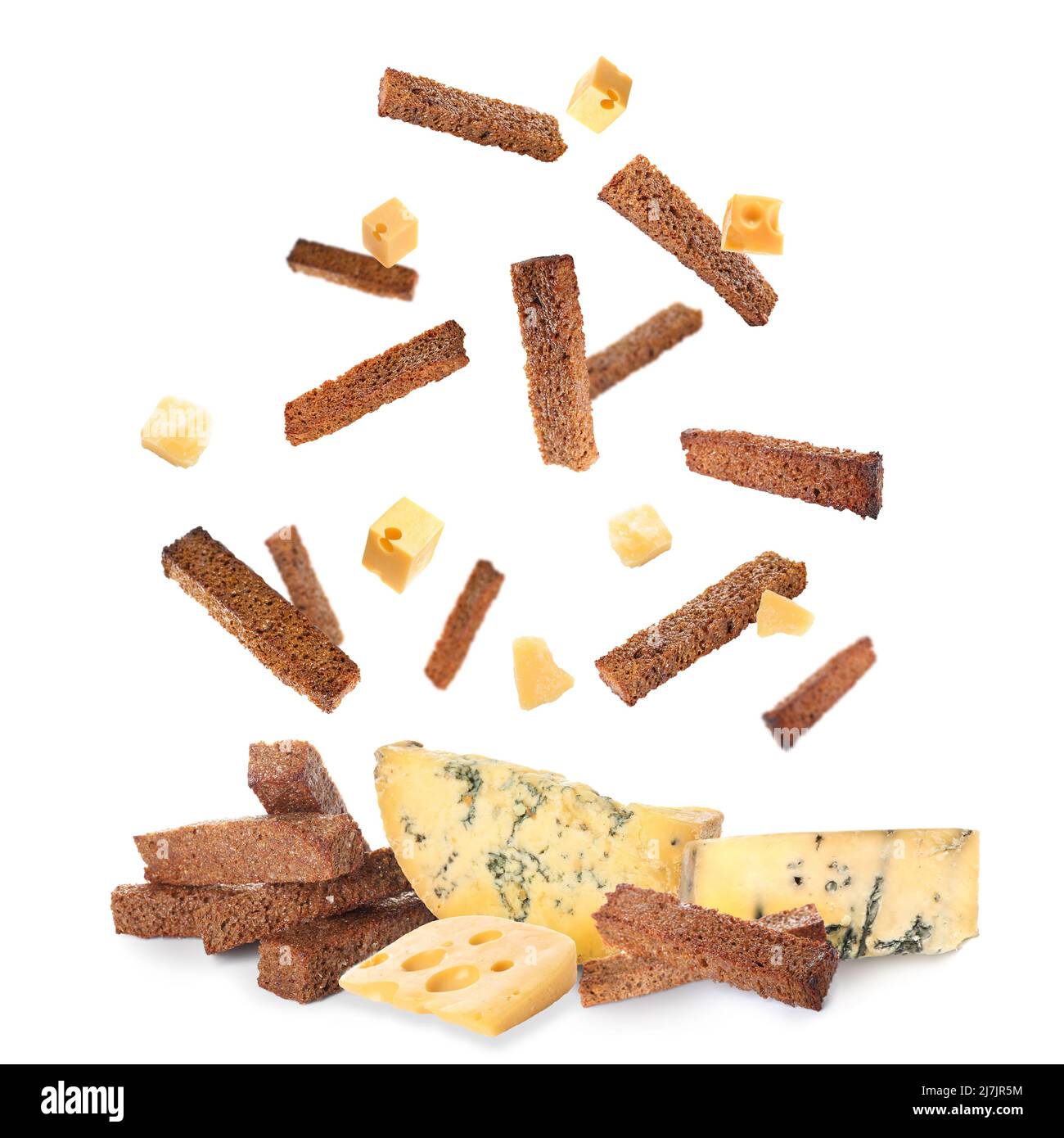 Falling rye croutons with cheese on white background Stock Photo