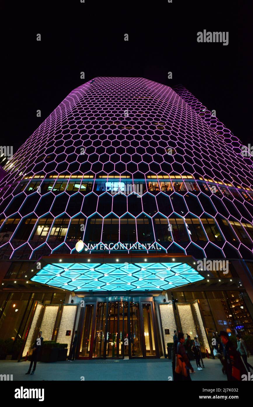The Intercontinental Sanlitun Tongying Center hotel illuminated at night. Stock Photo